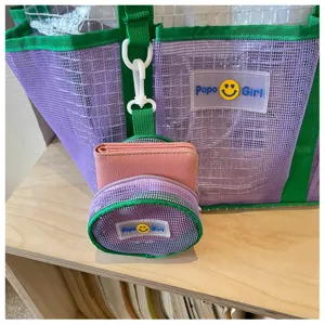 Detailed view of the purple and green mesh travel beach tote bag with cute small coin purse.