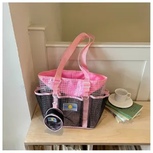 Detail view of a pink mesh tote beach bag with matching small coin purse for travel fitness.