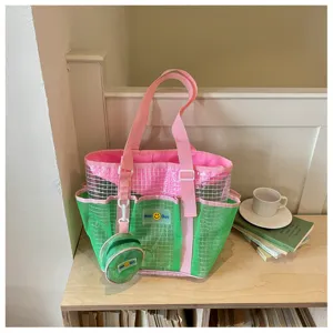 Details of the pink and green mesh beach travel bag with cute small pouch and shoulder strap.