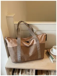 Large capacity travel duffel bag with expandable design, stylish brown and beige color block.