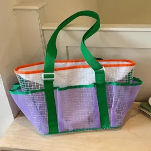 Stylish mesh beach bag for travel and fitness, multi-pocket waterproof tote bag in green and purple.