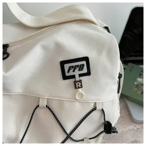 White travel duffel bag detail, large capacity waterproof sports bag with elastic cords.