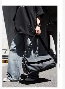 Stylish large capacity travel shoulder bag, durable grey gym duffel for business commute.