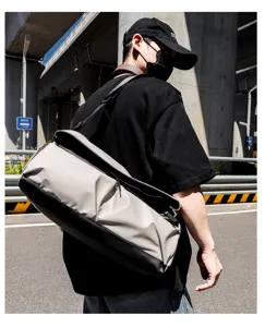 Stylish multi-functional travel shoulder bag for men, large capacity commuting messenger bag.