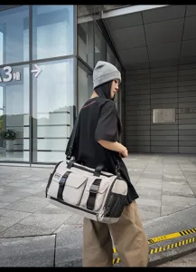 Multifunctional canvas travel duffle bag with multiple front pockets for outdoor fitness.