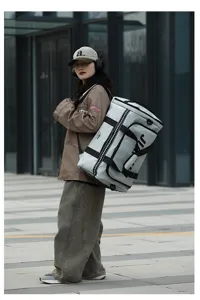 Detailed lifestyle view of the large capacity waterproof travel duffel bag in light grey.