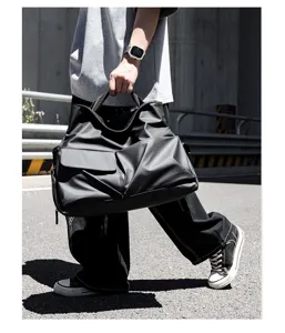 Stylish black travel duffel bag for men and women, large capacity waterproof weekender bag.