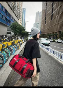 Large capacity red travel duffel bag with shoulder strap for sports and outdoor fitness.