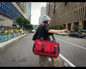 Large capacity red travel duffel bag for sports and fitness with adjustable shoulder strap.