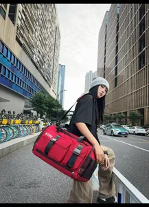 Large capacity red travel duffel bag, casual sports gym bag with shoulder strap and pockets.