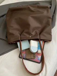 Solid color brown shoulder tote bag for women, casual commuter travel handbag with zipper.