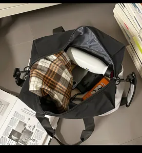Detail view of the spacious black travel bag interior, showing large capacity and storage.
