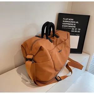 Large capacity travel duffel bag for women and men, lightweight sports gym shoulder bag.