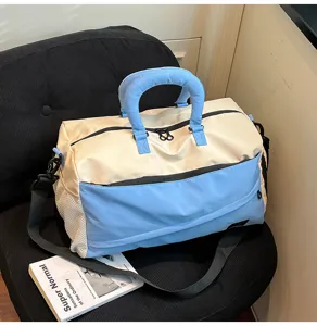 Color-blocked travel duffel bag with dual handles and shoulder strap for casual commuting.