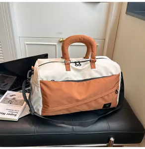 Color-blocked travel duffel bag with soft padded handles, spacious for gym, commute, and trips.