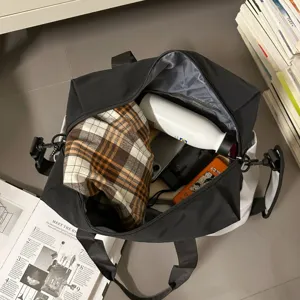 Detailed view of large capacity black travel duffel bag showing interior storage capacity.