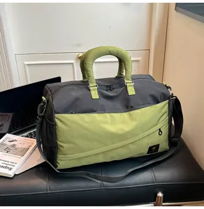 Detailed view of the stylish green and grey duffel bag featuring a durable handle and strap.