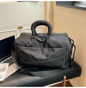Black travel duffel bag for men and women, durable shoulder bag for commute and short trips.