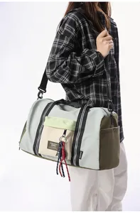 Detail view of large capacity travel duffel bag with front pocket and durable straps.