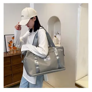Détails du grand sac de voyage imperméable en gris, idéal pour le sport et les loisirs.