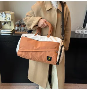 Color-block travel duffel bag for short trips, fitness, and daily commuting use.