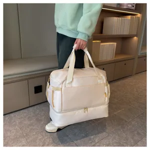 Detailed view of the large capacity travel duffel bag with bottom compartment and handles.