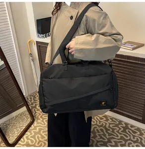 Black travel duffel bag with shoulder strap, soft fabric for commuting, fitness and outdoor.