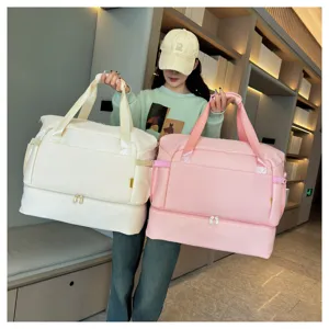 Large capacity travel duffel bag in white and pink, with bottom compartment and dual handles.