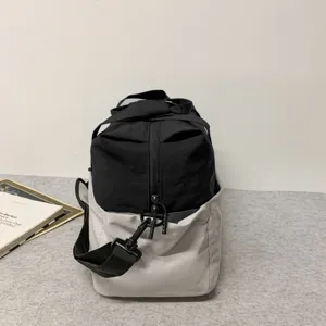 Close-up detail view of the black and grey travel duffel bag with sturdy zipper and strap.