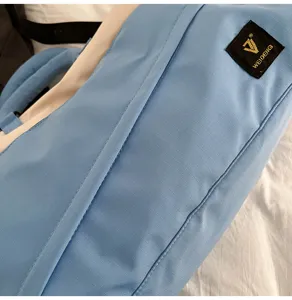 Detail view of color-blocked travel duffel bag, soft fabric shoulder bag for daily commute.
