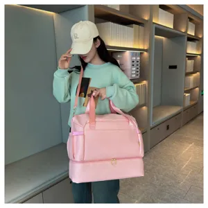 Large capacity pink travel duffel bag with separate bottom compartment for fitness and outdoor trips.