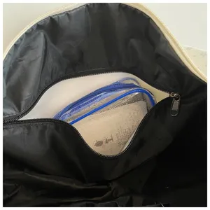 Detailed view of the large capacity sports travel duffel bag interior and waterproof pocket.