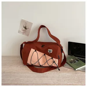 Detailed view of the large capacity travel gym bag with stylish pink panel and straps.