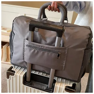 Large capacity travel duffel bag luggage sleeve feature detail shot on rolling suitcase handle