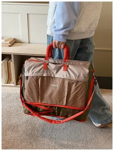 Large capacity travel duffel bag detail, casual canvas gym bag with durable shoulder strap.