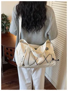 Large capacity canvas travel duffel bag with drawstring design for yoga and fitness sports use.