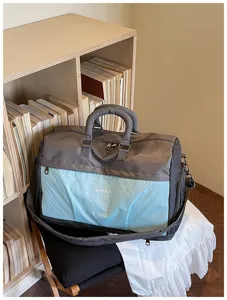 Large capacity travel duffel bag with grey and blue design, perfect for weekend trips and gym use.