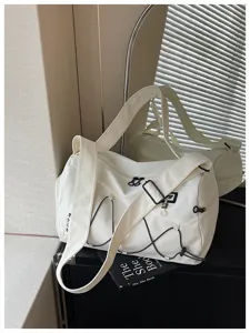 Large capacity white sports travel bag detail view, showing durable fabric and zipper quality.