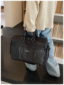 Large capacity travel duffel bag with front grid pocket, perfect for short trips and gym use.