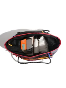 Black drawstring travel bag with red trim, lightweight outdoor sports gym tote for daily use.