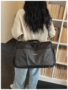 Large capacity travel duffel bag for short trips and gym fitness use. Black grid.
