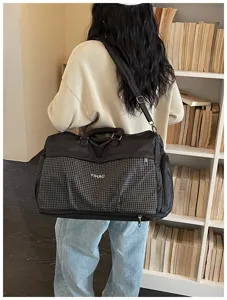Large capacity travel duffel bag with plaid pocket and shoulder strap for gym and business trips.