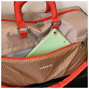 Large capacity travel duffel bag with red handles and front grid pocket for short trips gym.