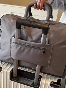 Large capacity travel duffel bag with trolley sleeve, grey overnight bag for business trips.