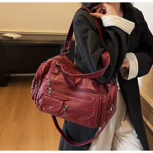 Vintage red multi-pocket motorcycle shoulder bag, spacious soft leather crossbody.
