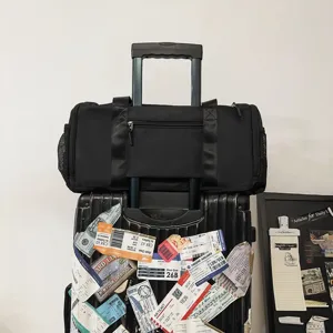 Black travel duffel bag with luggage sleeve, durable gym bag for men and women weekend trips.