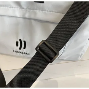 Detailed view of white travel duffel bag showing durable black adjustable strap and logo.