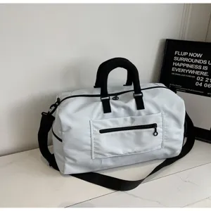 Detailed view of the large capacity solid white travel duffel bag with black straps and zip pocket.