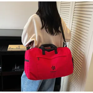 Large capacity red travel duffel bag with shoulder strap for fitness gym and outdoor sports.