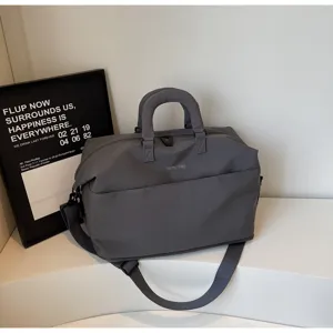 Versatile grey travel duffel bag with shoulder strap for short business trips storage